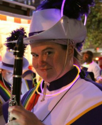 Image is a women in marching band uniform with a clarinet. LGBAC photo courtesy of Marek Marcinkowski.
